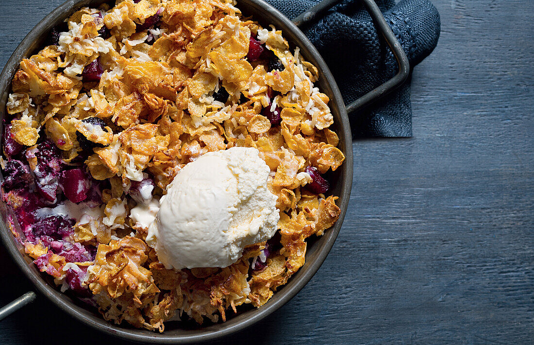 Apple and blackberry crumble with cornflakes and vanilla ice cream