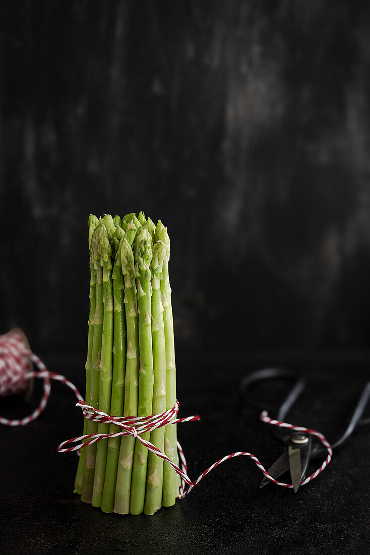Bunch of green asparagus wrapped in kitchen twine