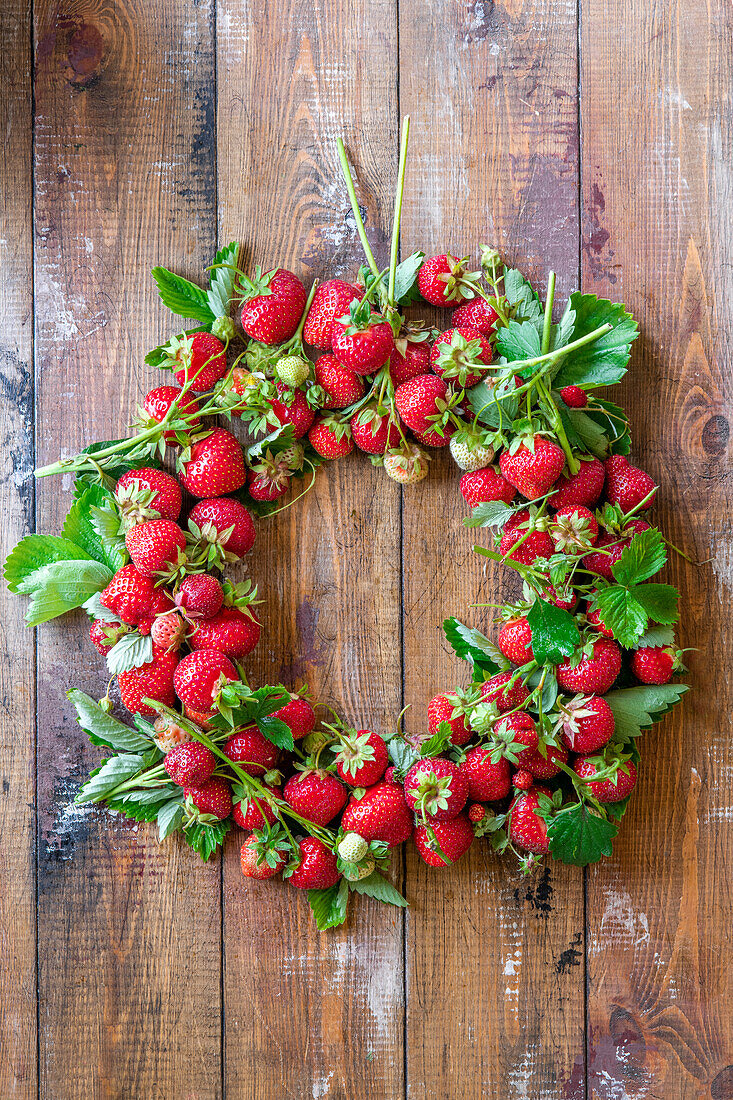 Wreath of fresh strawberries with leaves
