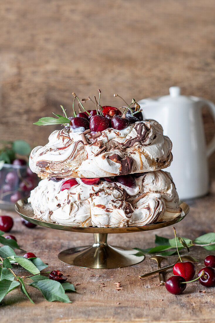 Pavlova cake with chocolate and fresh cherries