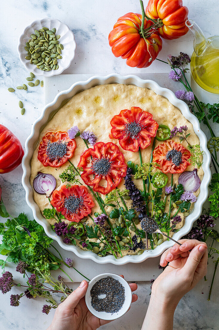 Garden focaccia with tomatoes, herbs and flowers