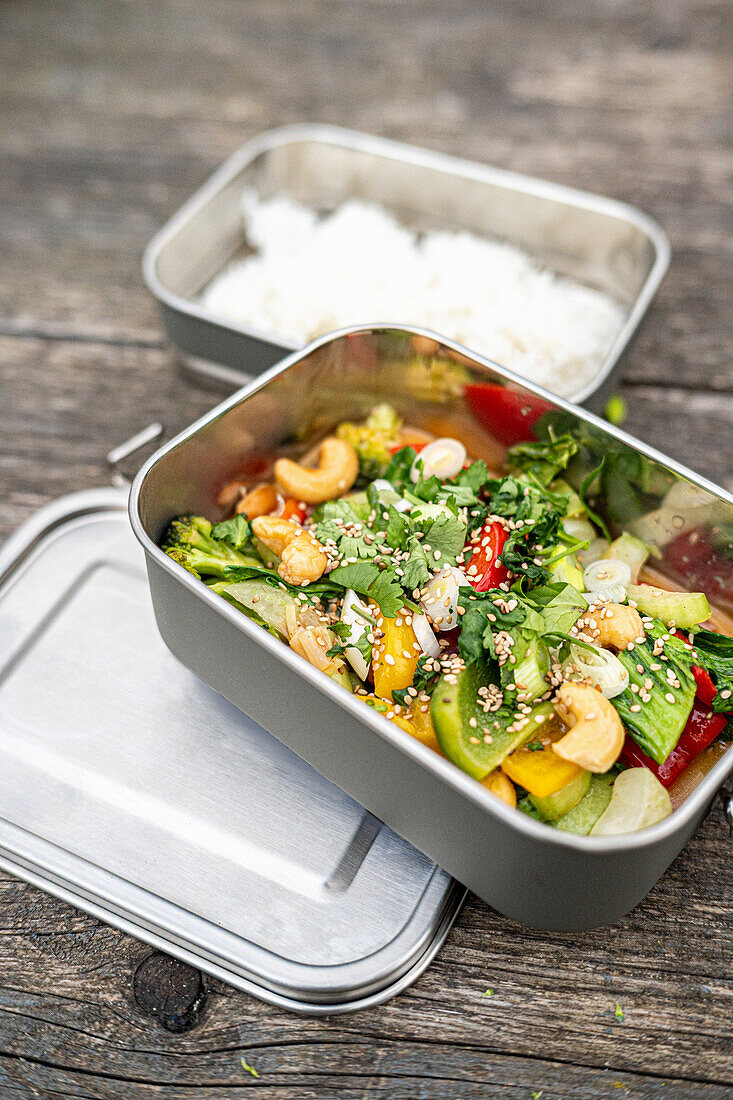 Thai vegetable curry with rice in metal containers