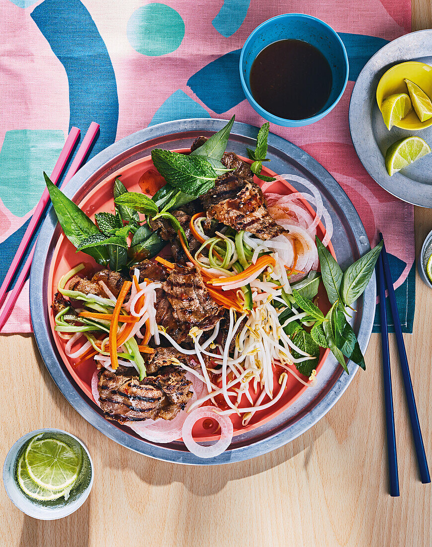 Vietnamese noodle salad with grilled meat and vegetables