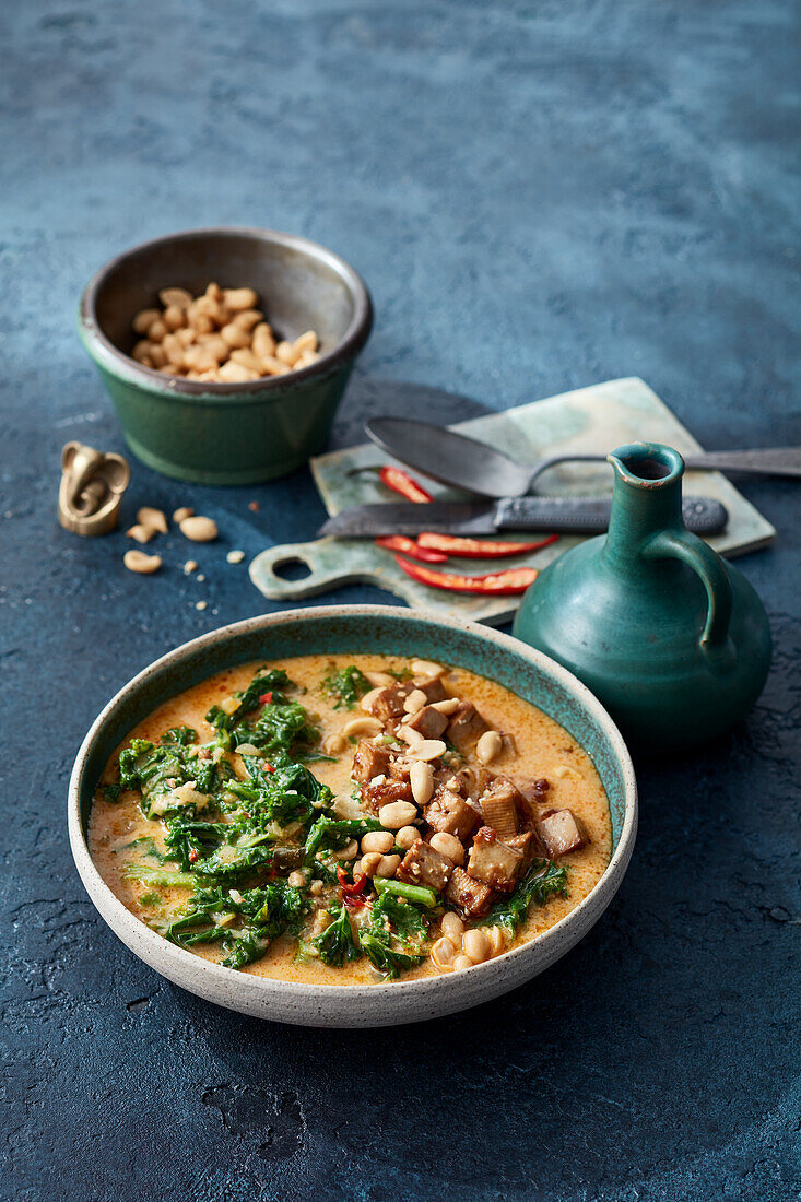 Indian green cabbage curry with crispy tofu and peanuts