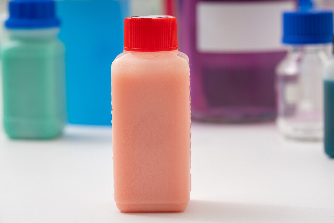 Plastic bottle with red liquid, conceptual image