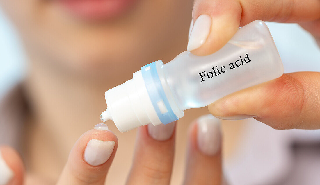 Folic acid medical drops, conceptual image