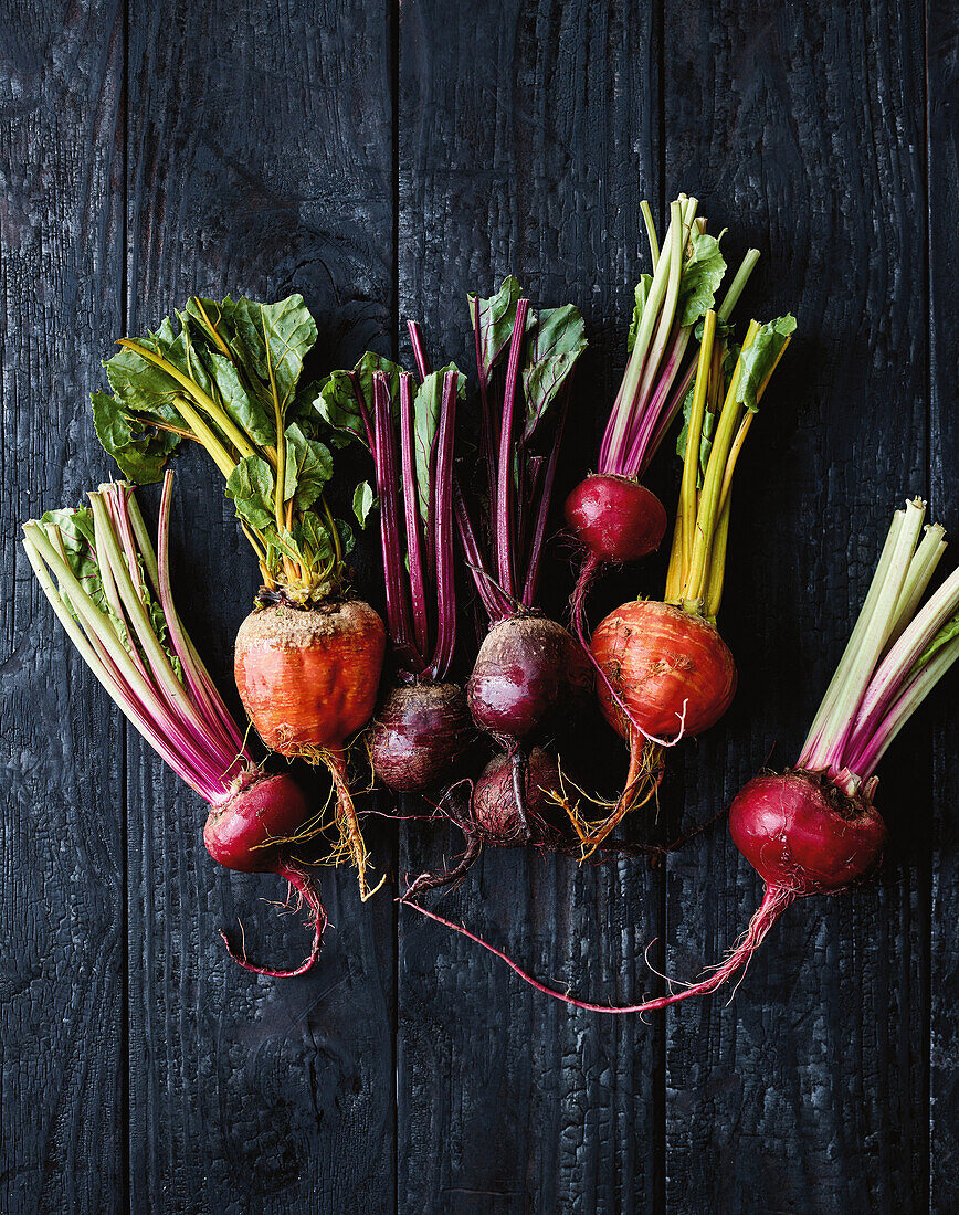 Different types of fresh beetroot on a wooden background