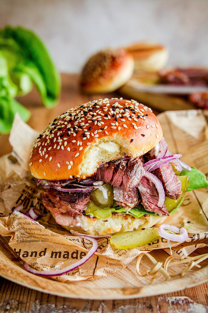 Pastrami burger with gherkins and onions