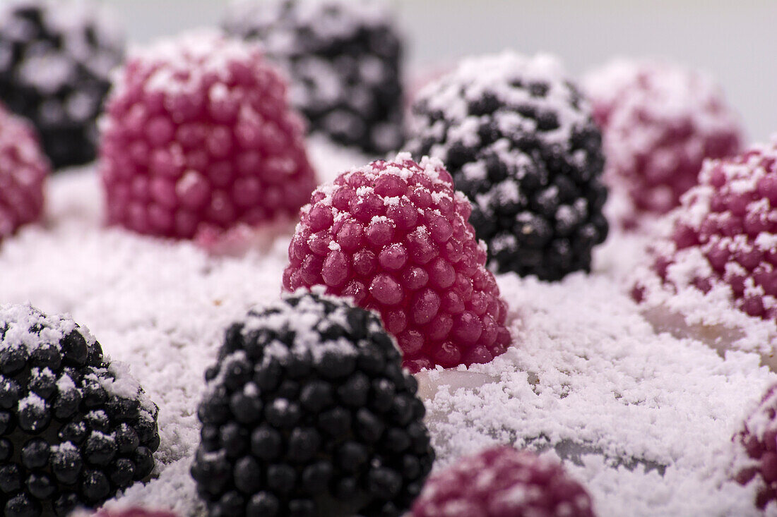 Blackberry and raspberry sweets dusted with icing sugar
