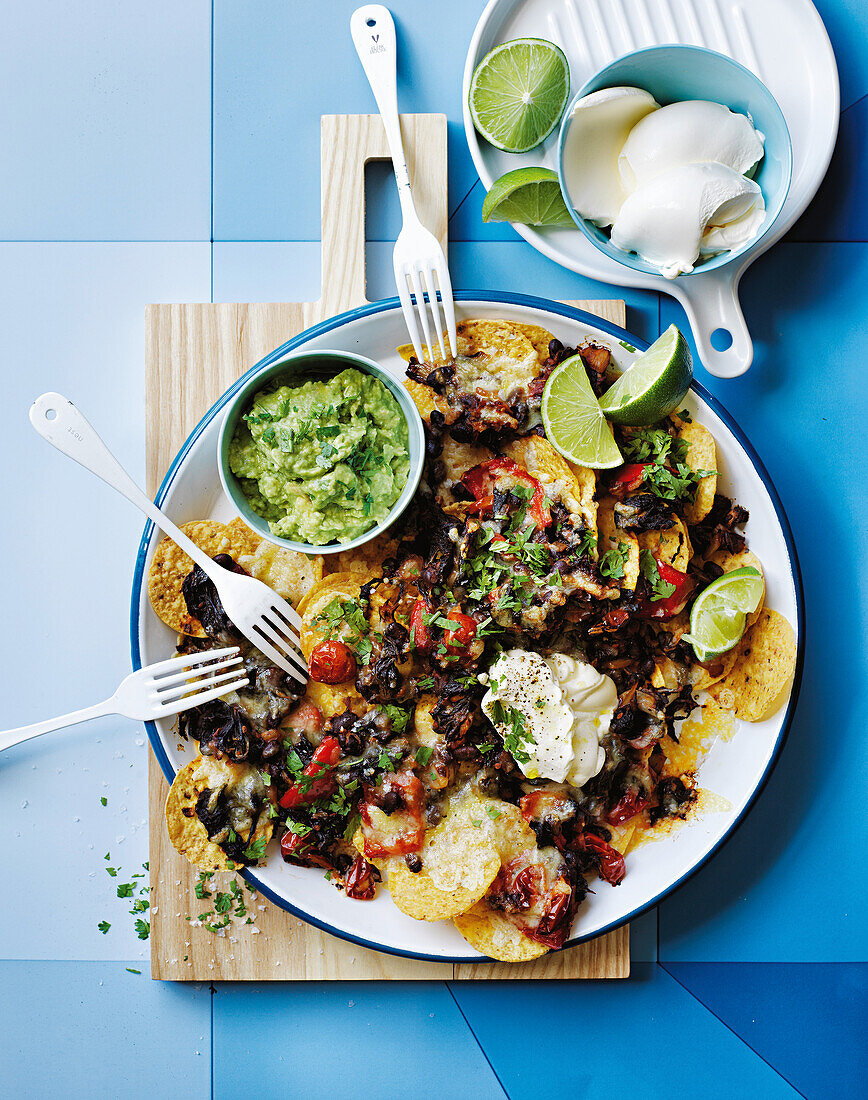 Vegetarian nachos with guacamole and lime