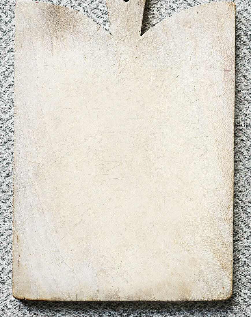 Empty chopping board on a patterned background