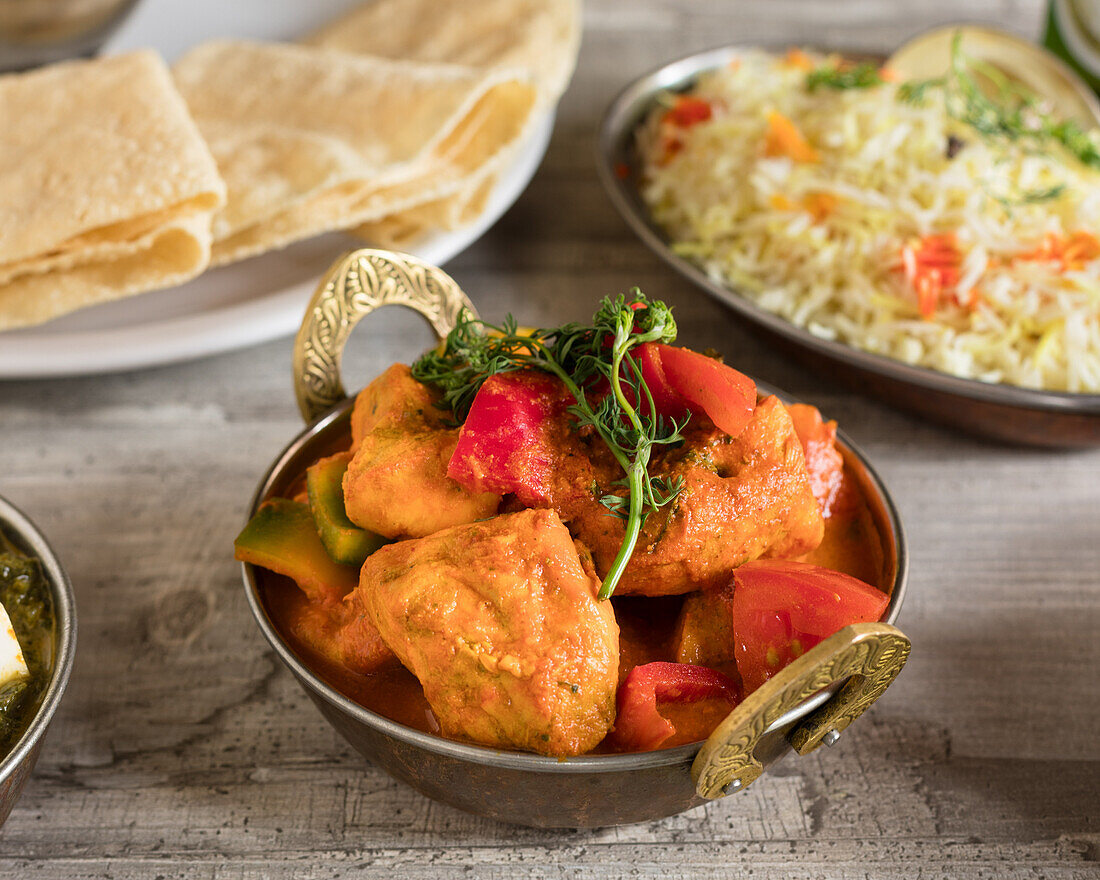 Indian chicken tikka masala with rice and papadam