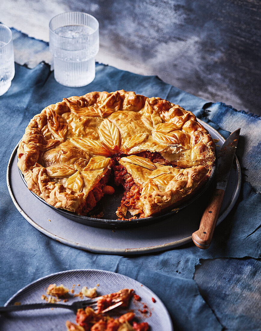 Puff pastry pie with bacon and bean filling