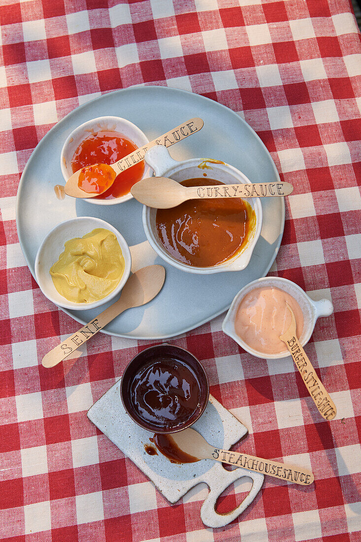 Barbecue sauces with labelled disposable spoons