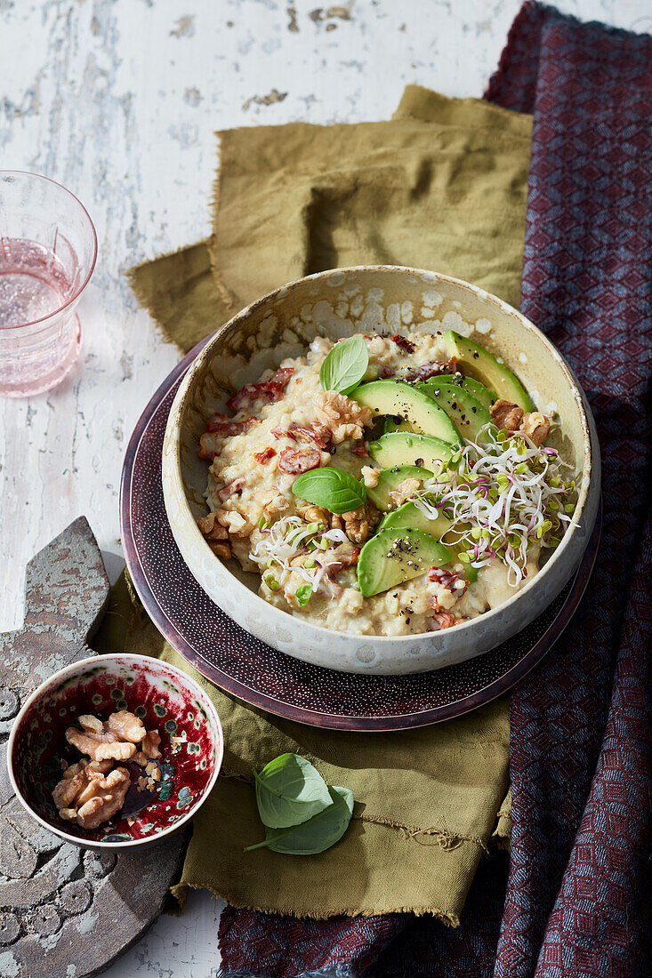 Hearty spelt porridge with avocado and sprouts