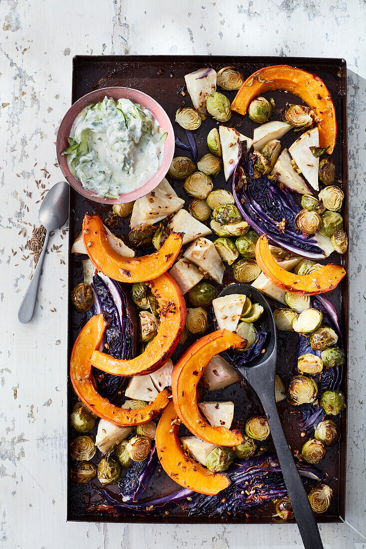 Winter oven vegetables with cashews and cucumber raita