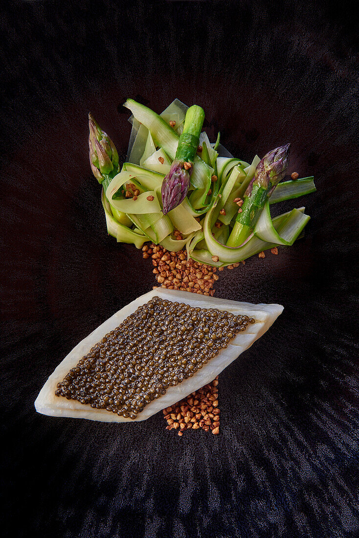 Fried fillet of St Peter's fish with caviar, asparagus and courgette strips