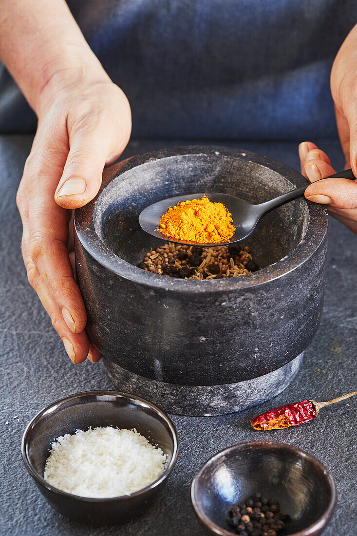 Making a masala spice mix in a mortar and pestle