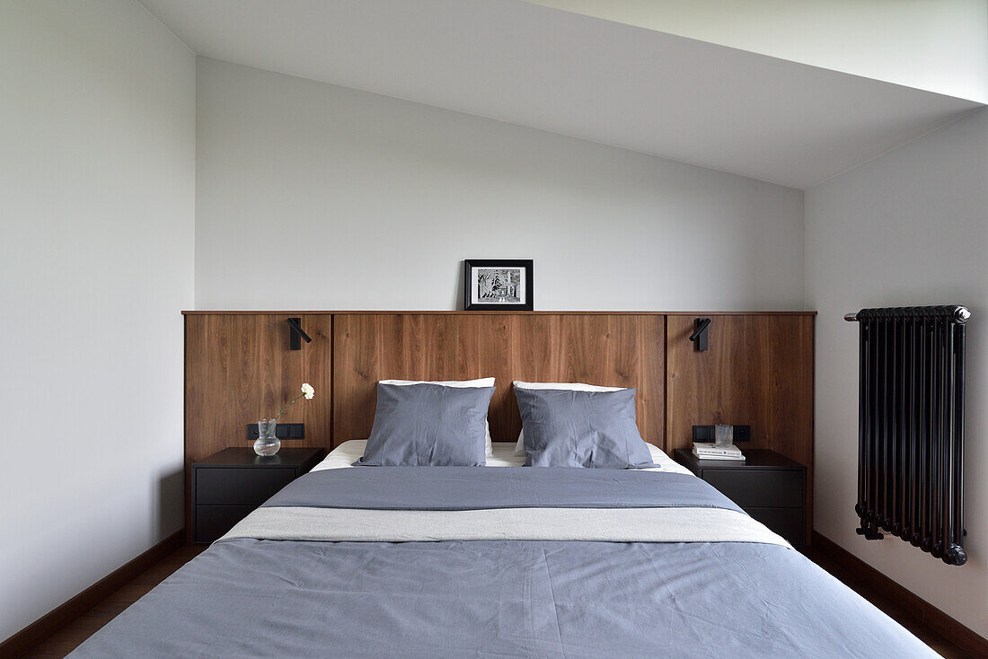 Bedroom with wooden headboard and built-in bedside tables