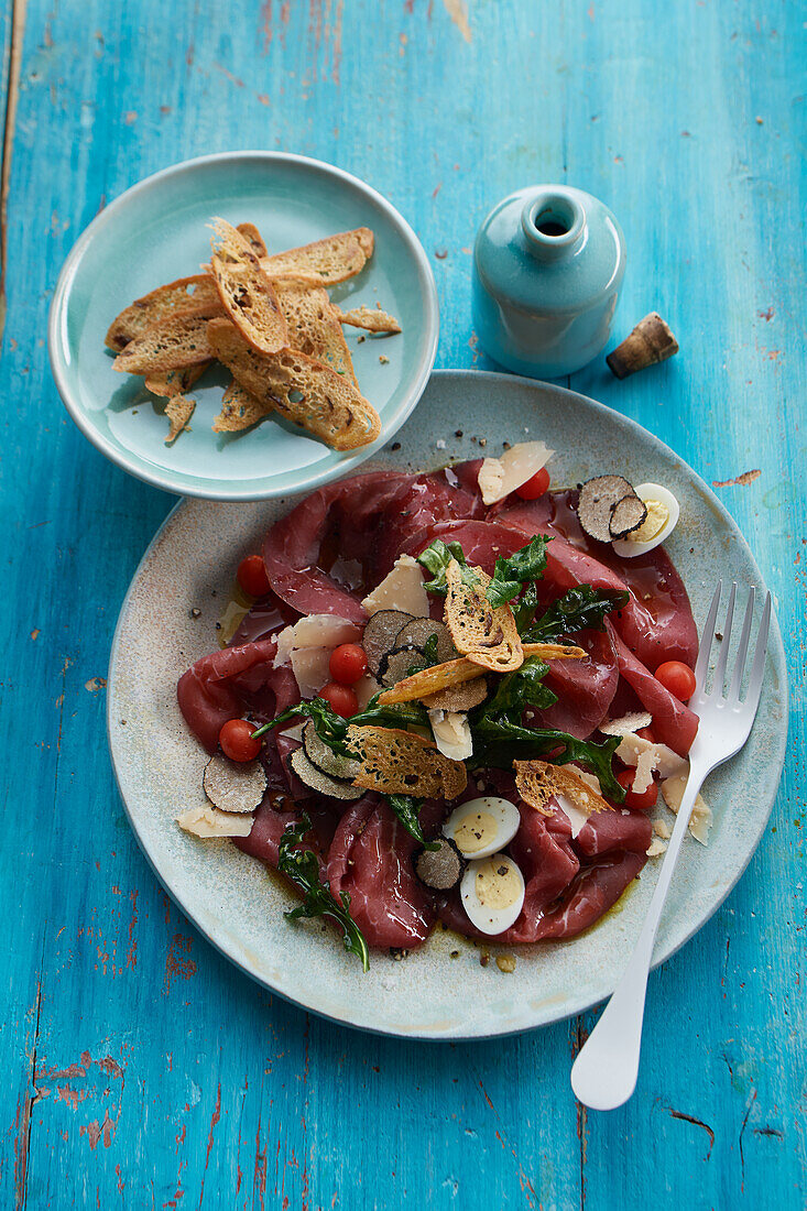 Bresaola carpaccio with truffle oil, parmesan and quail eggs