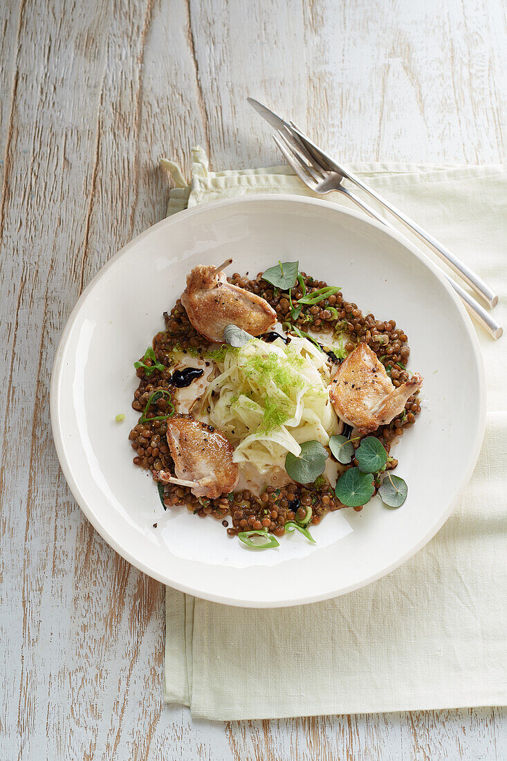 Pink roasted quail breast on caramelised lentils