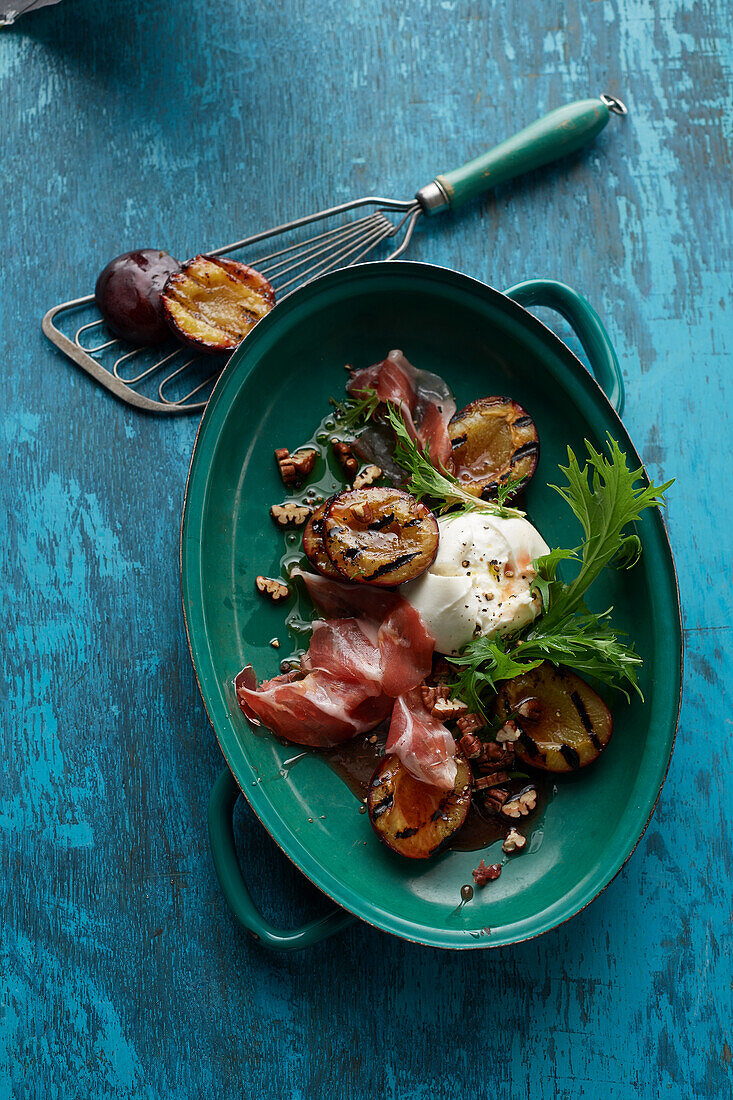 Grilled plums and burrata in spiced syrup with Iberico ham