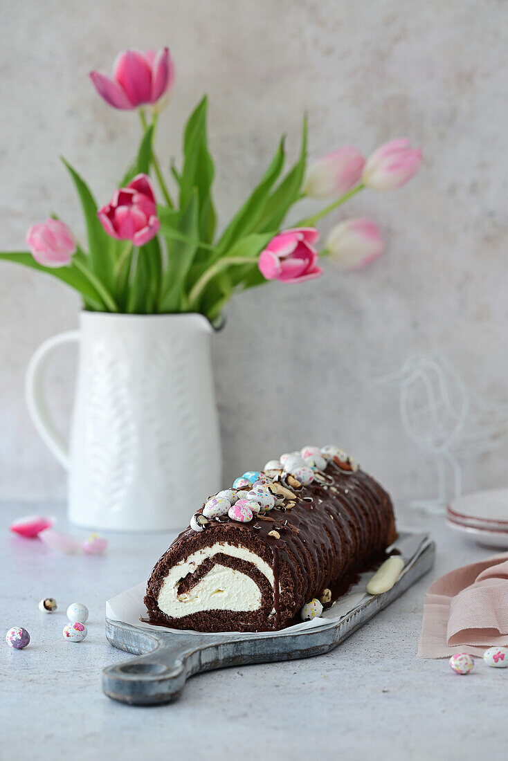 Chocolate sponge roll with cream cheese filling and Easter decoration