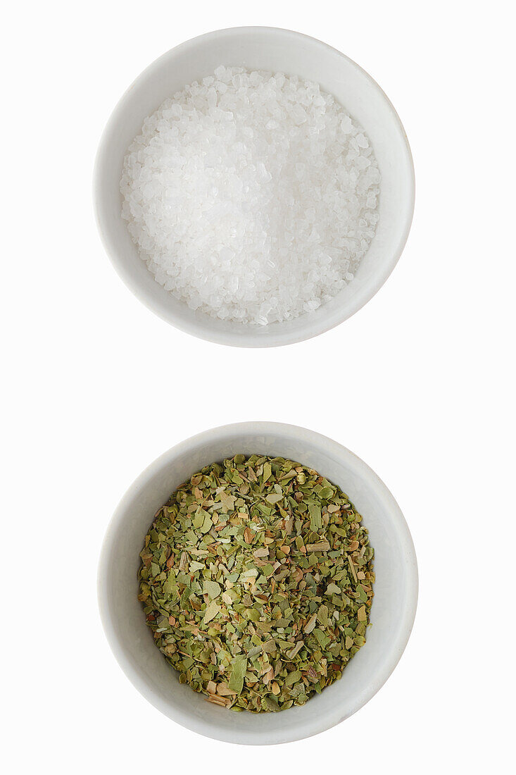 Sea salt and dried oregano in bowls