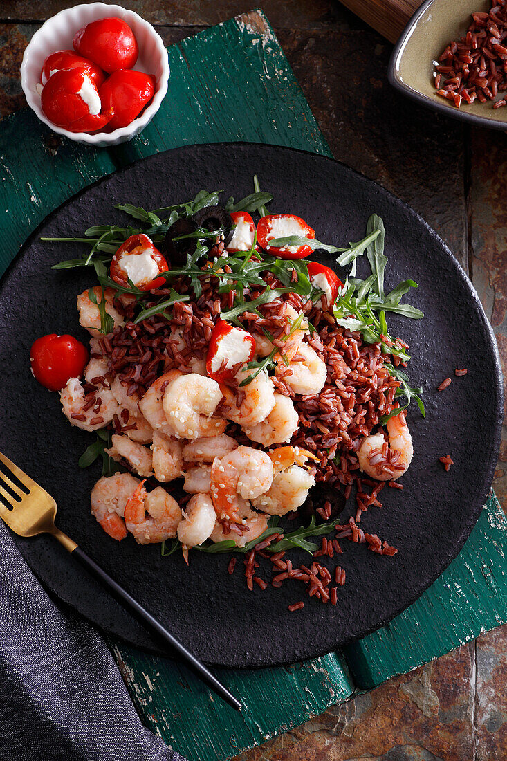 Fried prawns on wild rice with rocket and stuffed cherry tomatoes