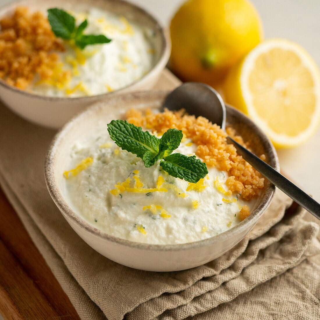 Lemon mousse with biscuit crumbs and mint