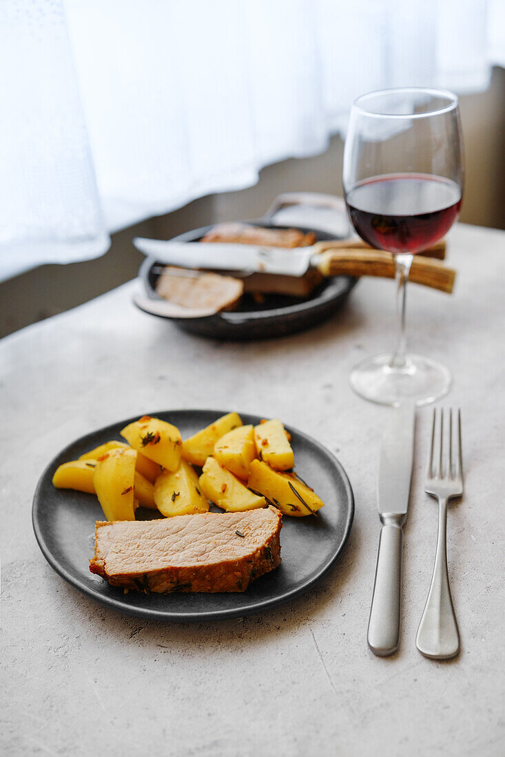 Baked pork fillet with rosemary and potato wedges