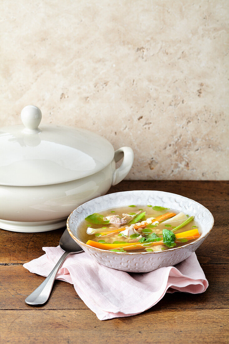 Chicken soup with colourful vegetables and pearl noodles