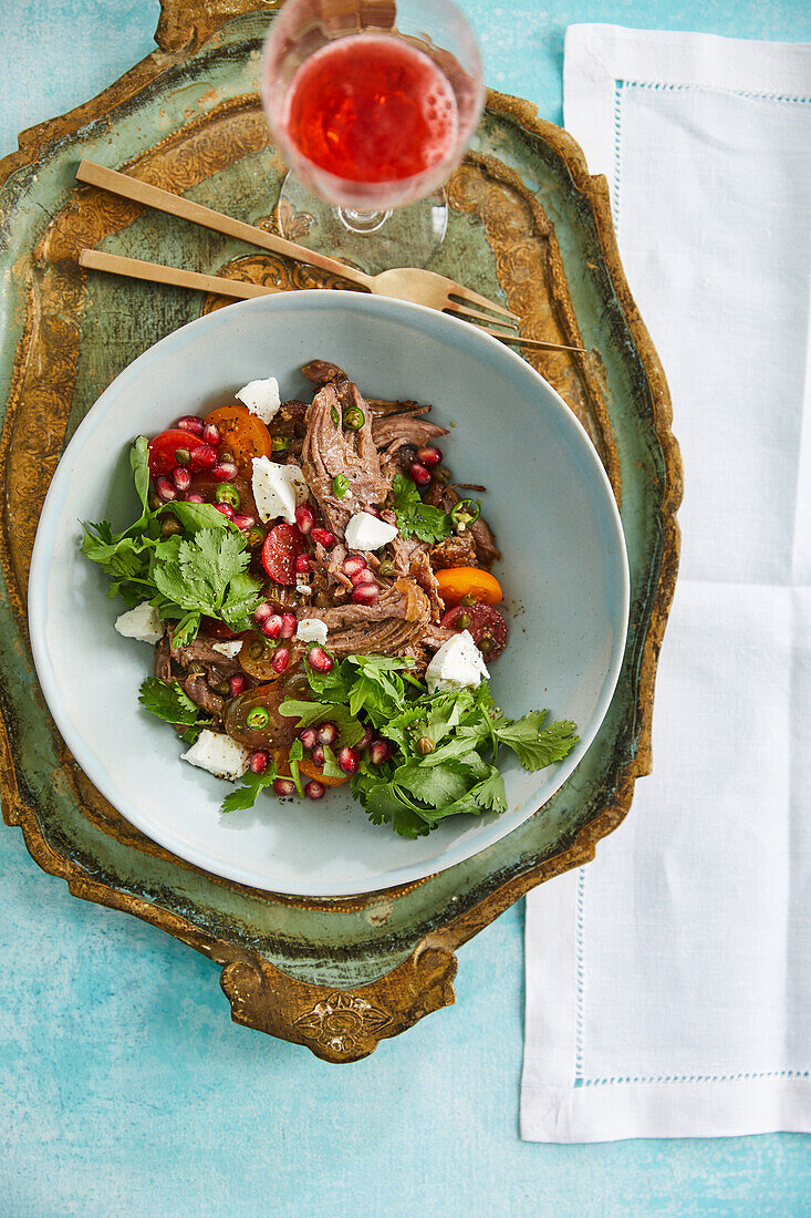 Plucked lamb shoulder with herbs and pomegranate seeds