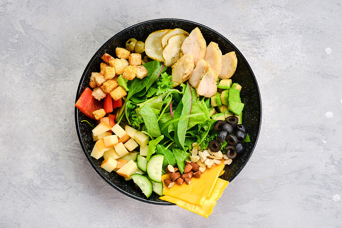 Bowl with salad mix and various snacks as a starter