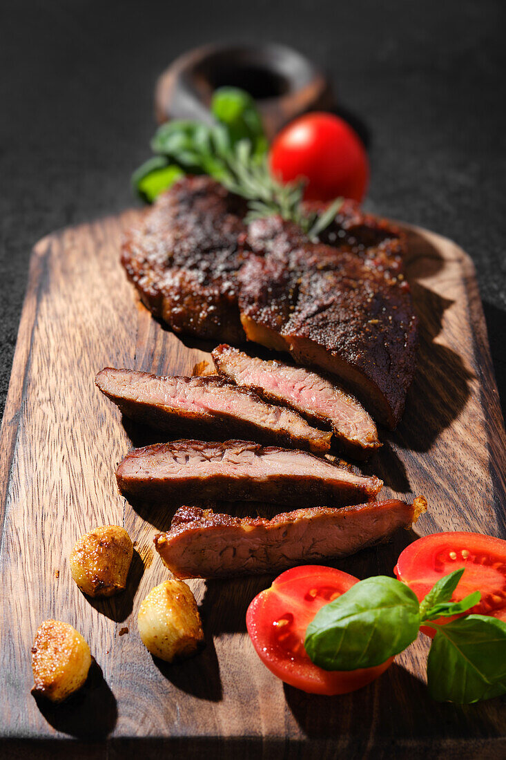 Roast beef steak with tomato and herbs