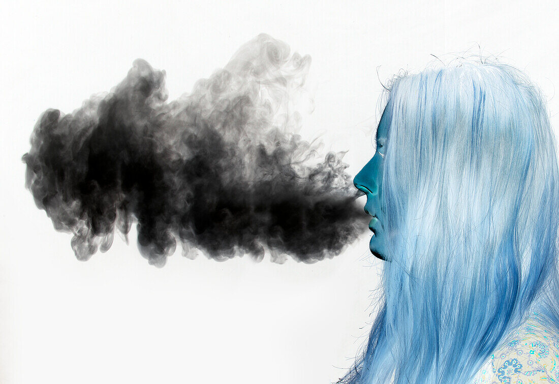 Woman exhaling vapour