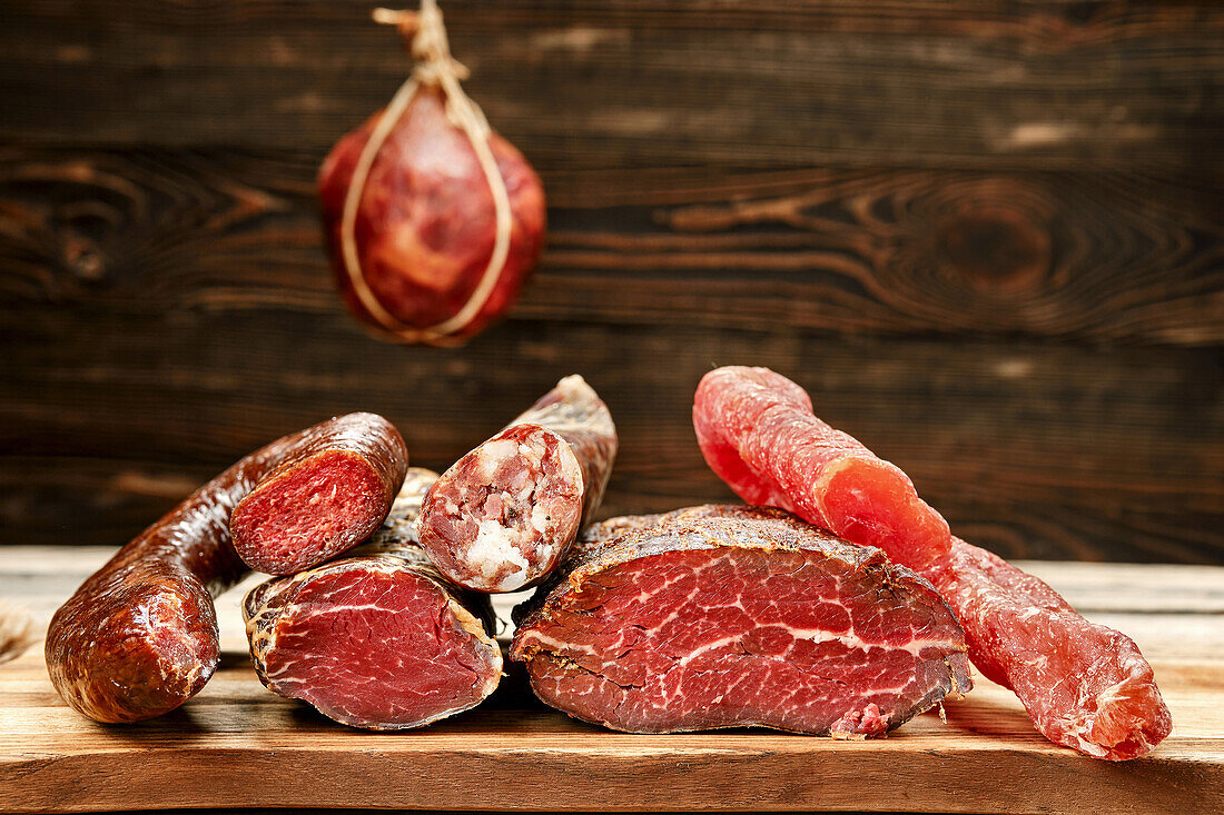 Various types of air-dried meat and sausage in one piece