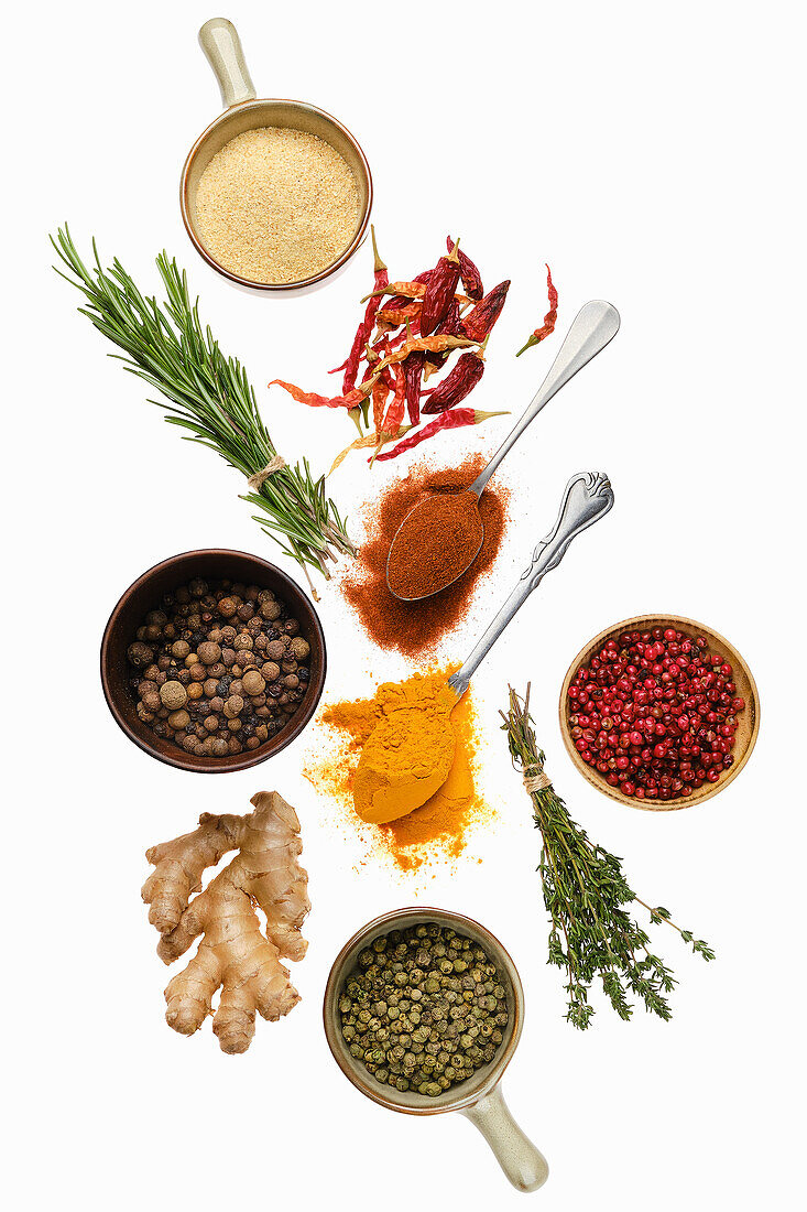 Various spices and herbs on a white background