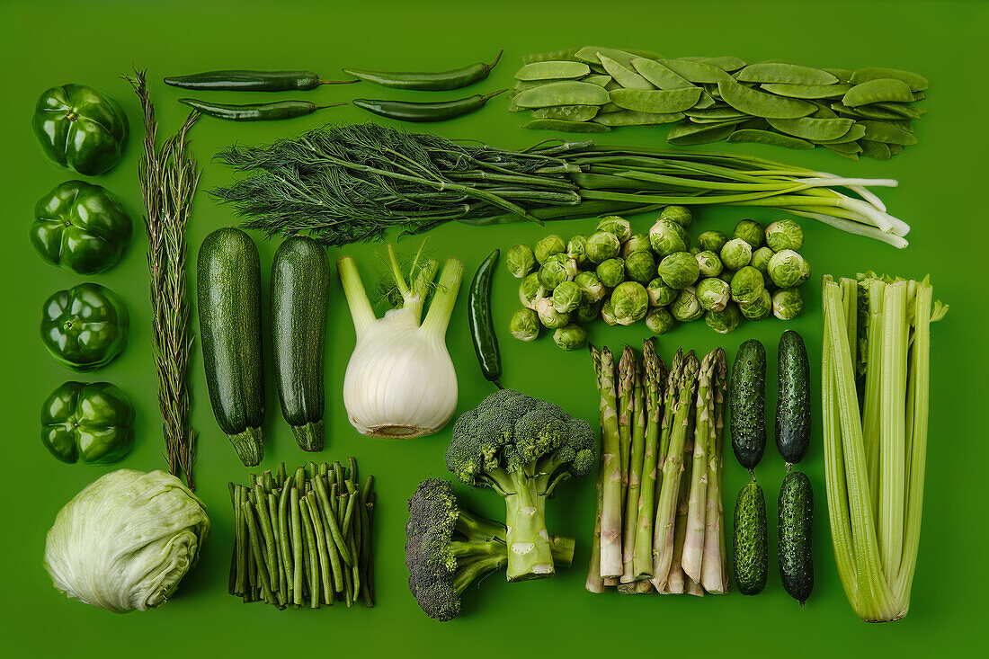 Various green vegetables on a green background