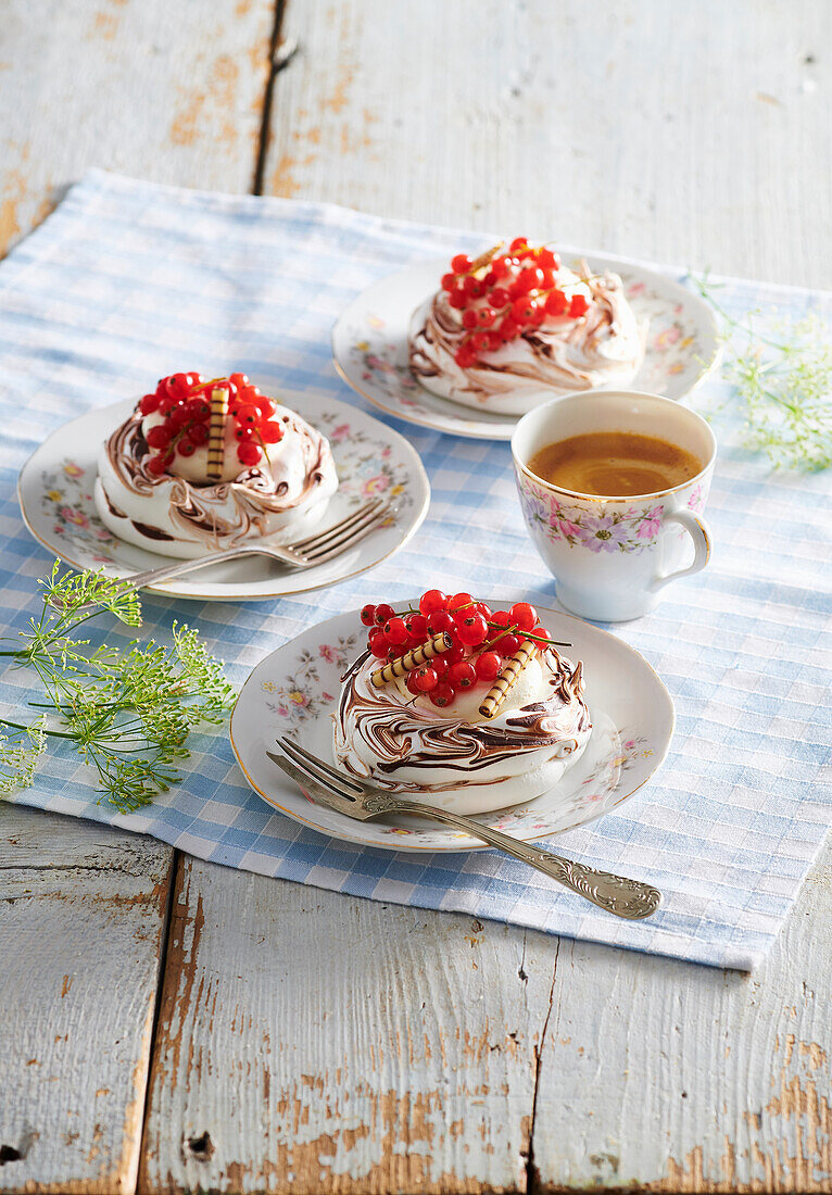 Mini pavlovas with redcurrants and wafer rolls