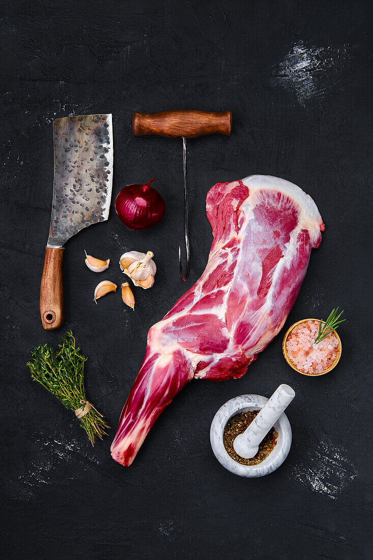 Raw leg of lamb with bone and herbs