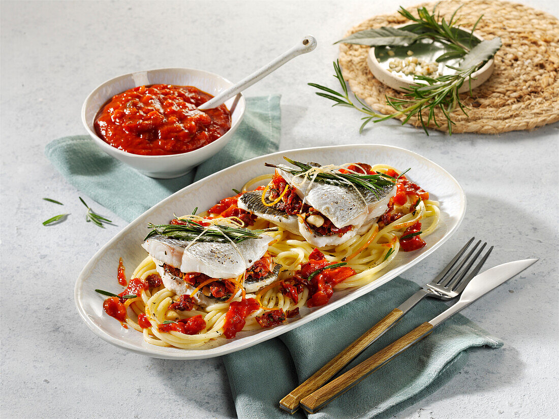 Mediterrane Fisch-Päckchen mit Tomaten auf Pasta