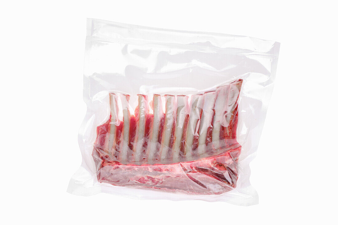 Vacuum-packed lamb ribs on a white background