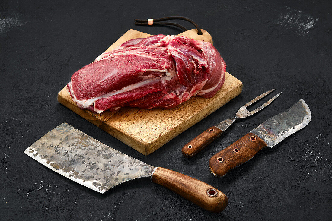 Raw boneless rack of lamb on chopping board