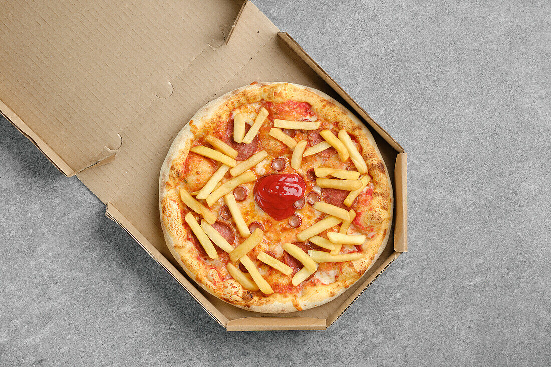 Pizza with sausages and chips