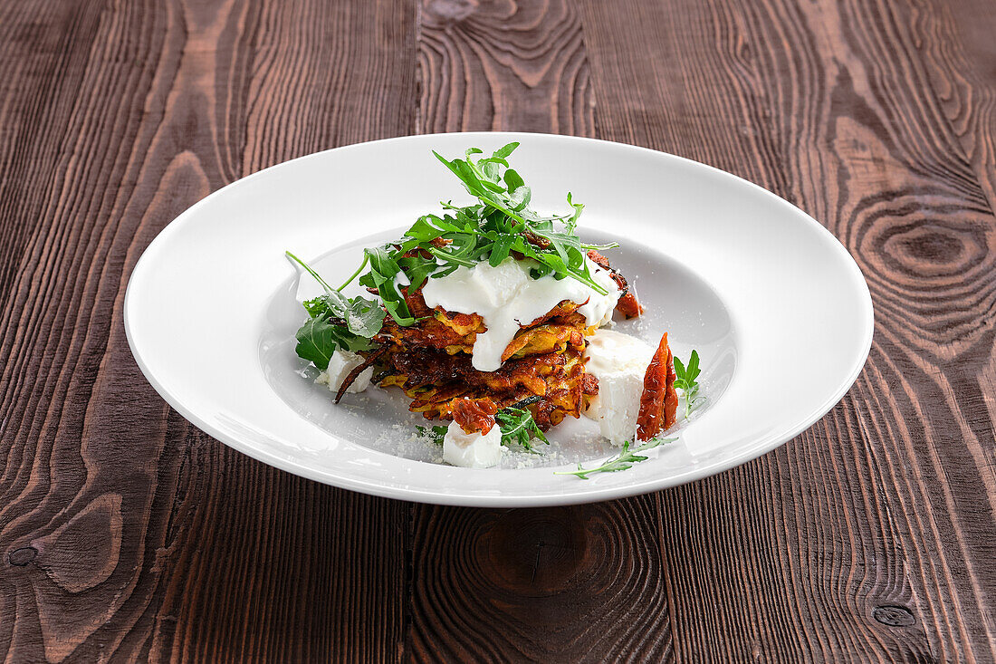 Pumpkin pancakes with sour cream and sun-dried tomatoes