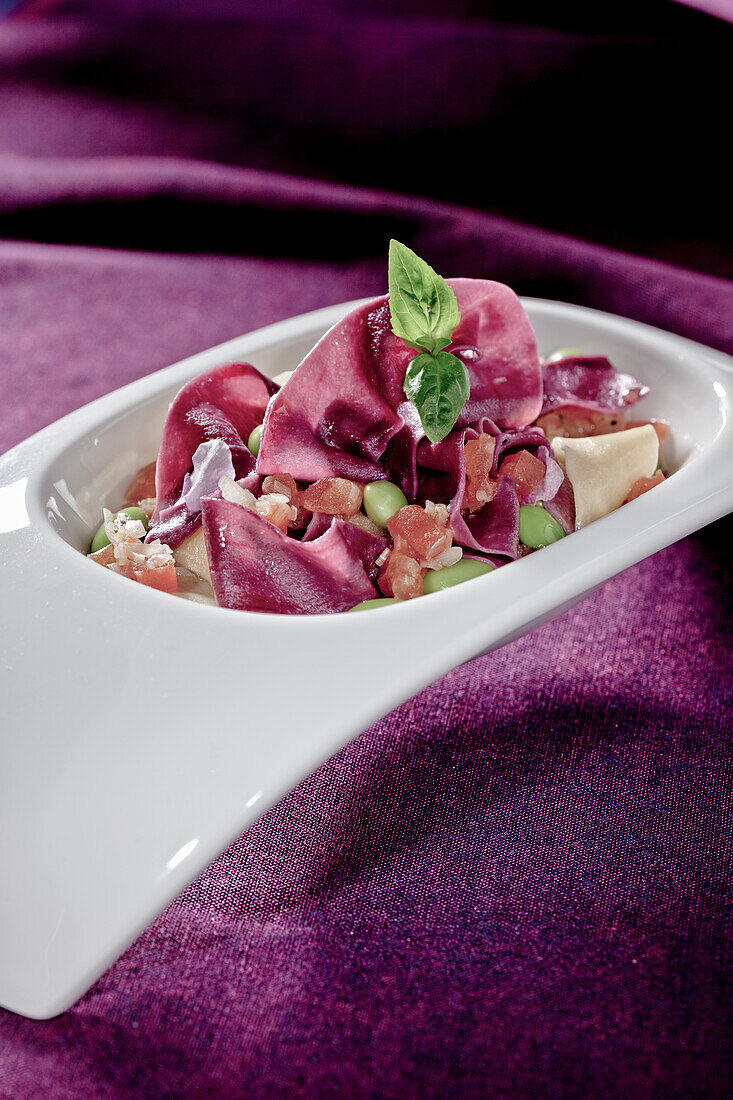 Beetroot tagliatelle with broad beans and tomatoes