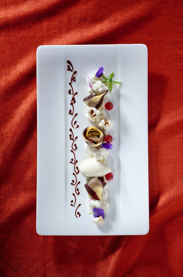 Nougat tortellini with popcorn and white mousse