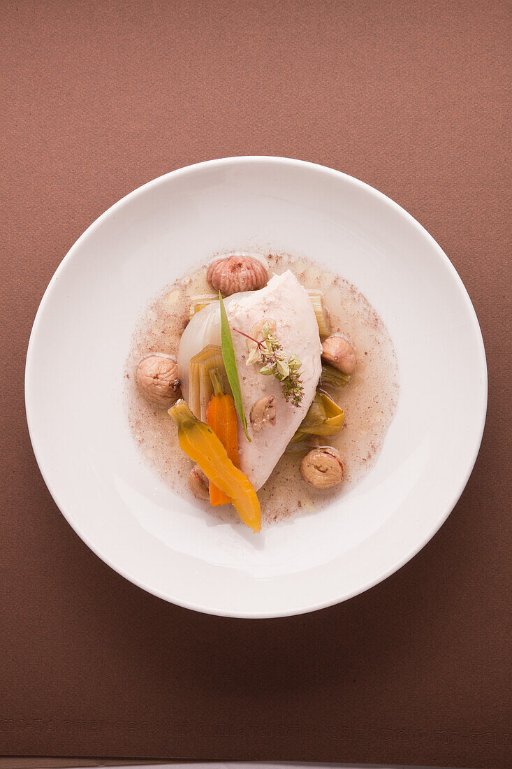 Poached chicken breast with vegetables and chestnuts