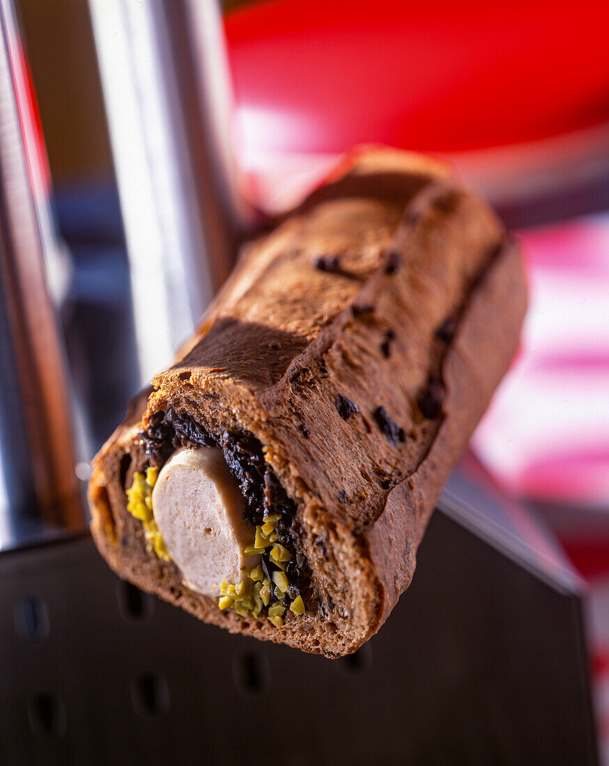 Wholemeal baguette hot dog with boudin blanc and olives